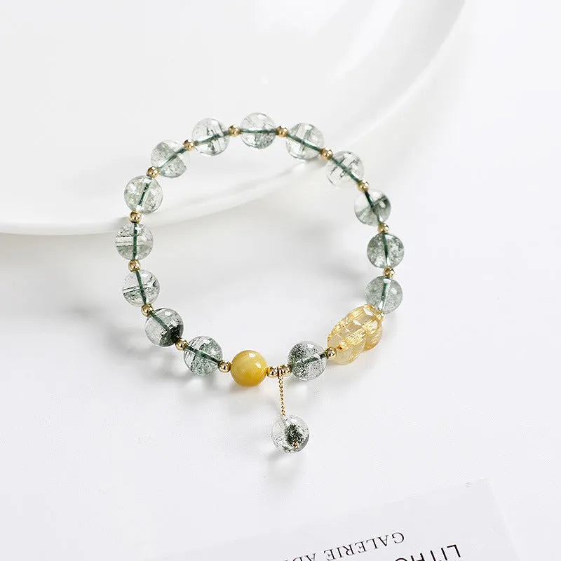 Green Phantom Quartz bracelet with gold rutile patterns in geometric 8mm beads