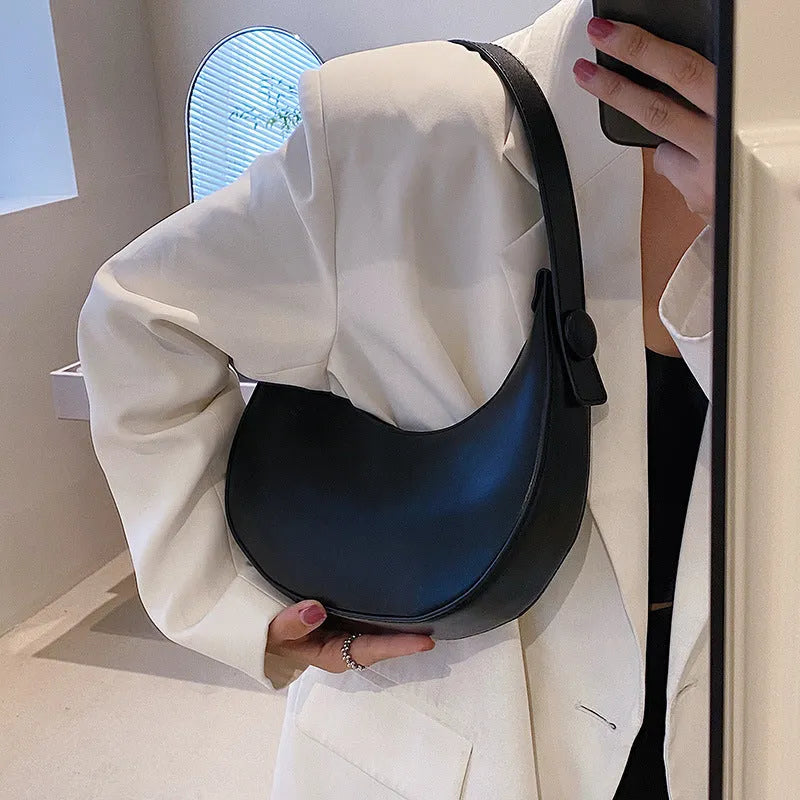 Women's retro-style PU leather shoulder bag in a dumpling shape, shown in black.