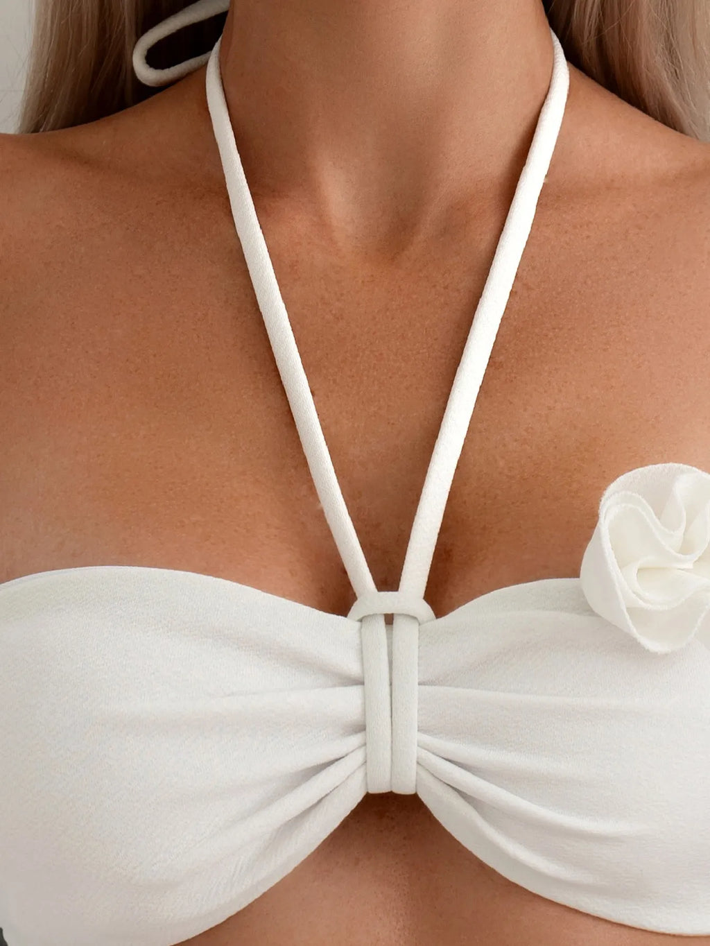 White women's swimsuit with 3D floral pattern, halter neck, and lace-up back.