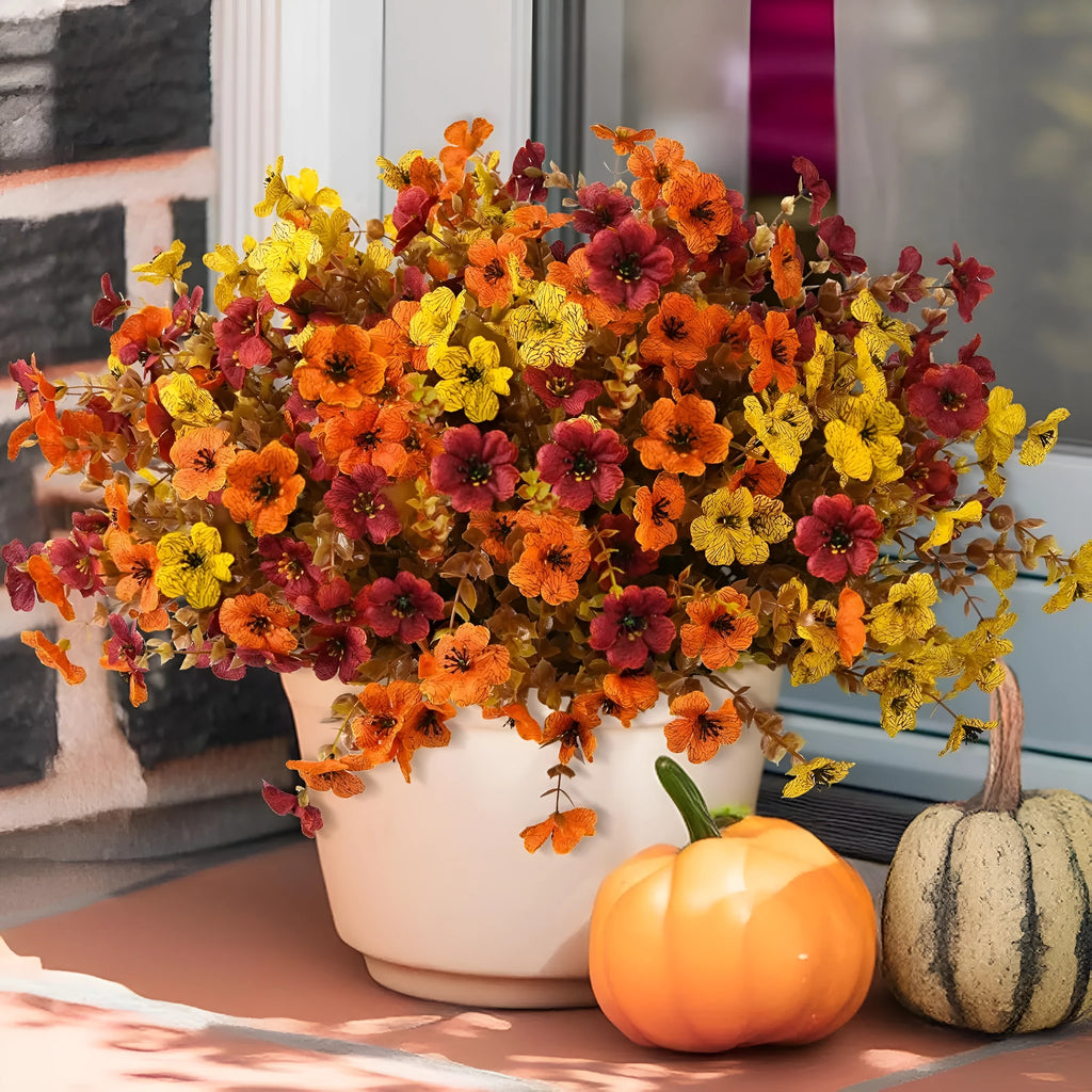 Artificial flower bouquet with autumn orange, red, and yellow silk flowers on plastic stems for decoration