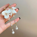 Women's acrylic pearl tassel earrings with four attachment styles showing 8.8cm length