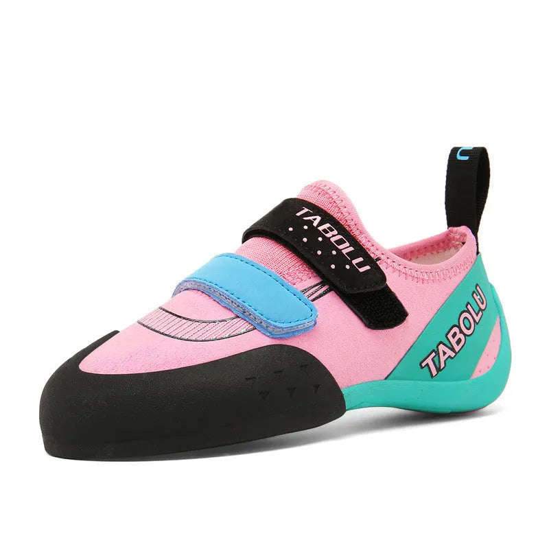 Beginner rock climbing shoes with Velcro strap in black and red colourway.