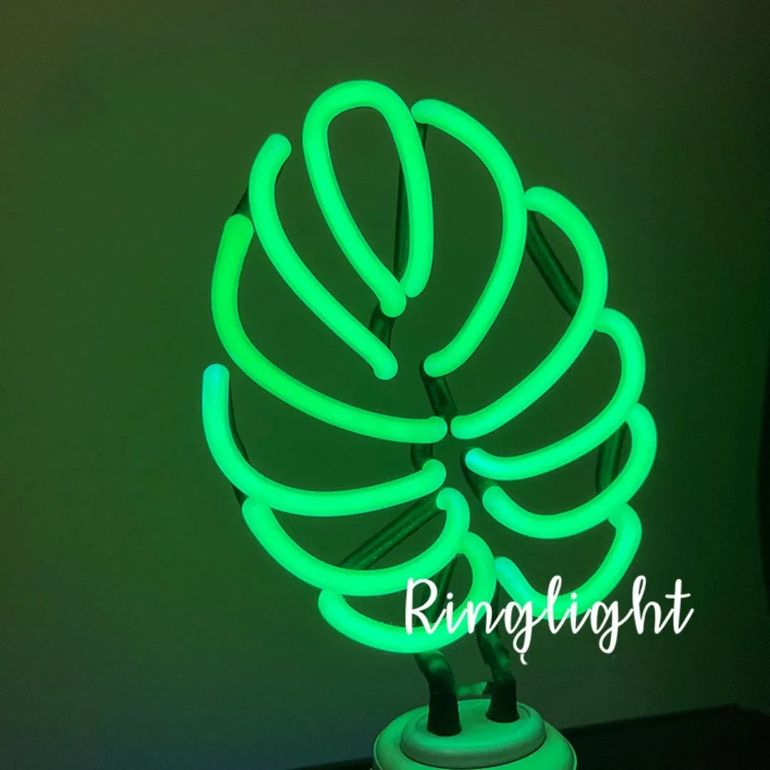 White minimalist bamboo-shaped desk lamp with green light, showing large and small size options.