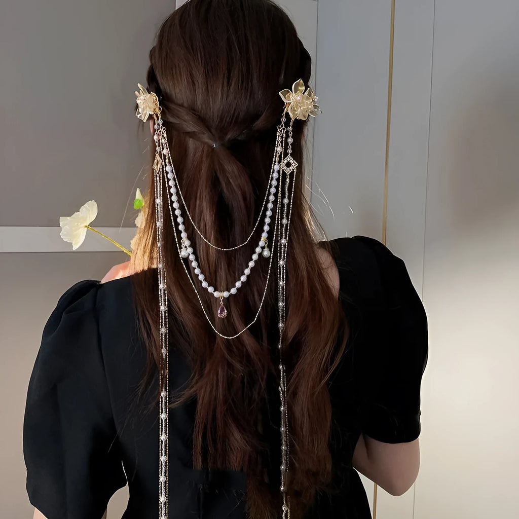 Women's gold pearl diamond flower long tassel hairpin on white background