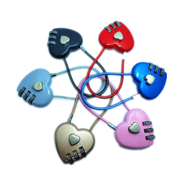 Peach heart shaped combination lock with a long black steel cable, shown in blue plastic.