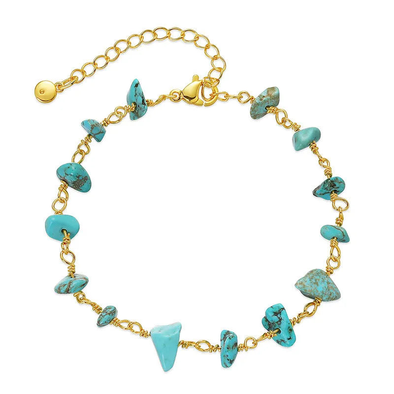 Geometric women's copper bracelet with irregular turquoise gravel stones and crystal accents on a white background.