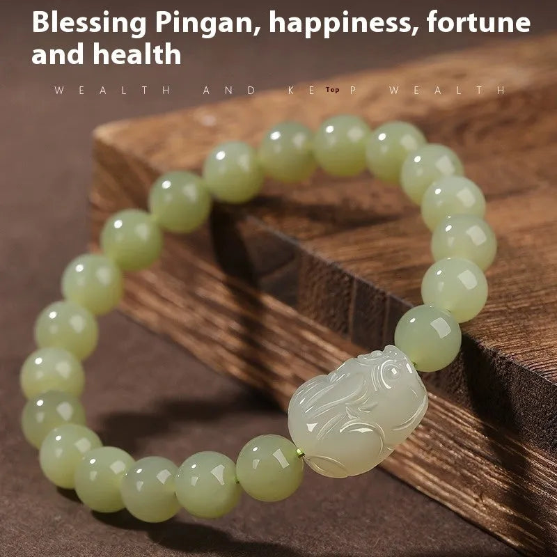 Grey Hetian jade ethnic style bracelet with polished beads on a wrist.
