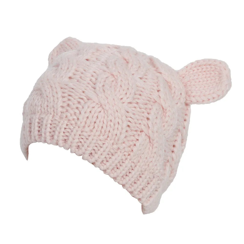 Red hand-knitted wool beanie hat with 3D cat ears on a white background.
