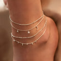 Alloy anklet with fruit-themed design and crystal inlay on a neutral background