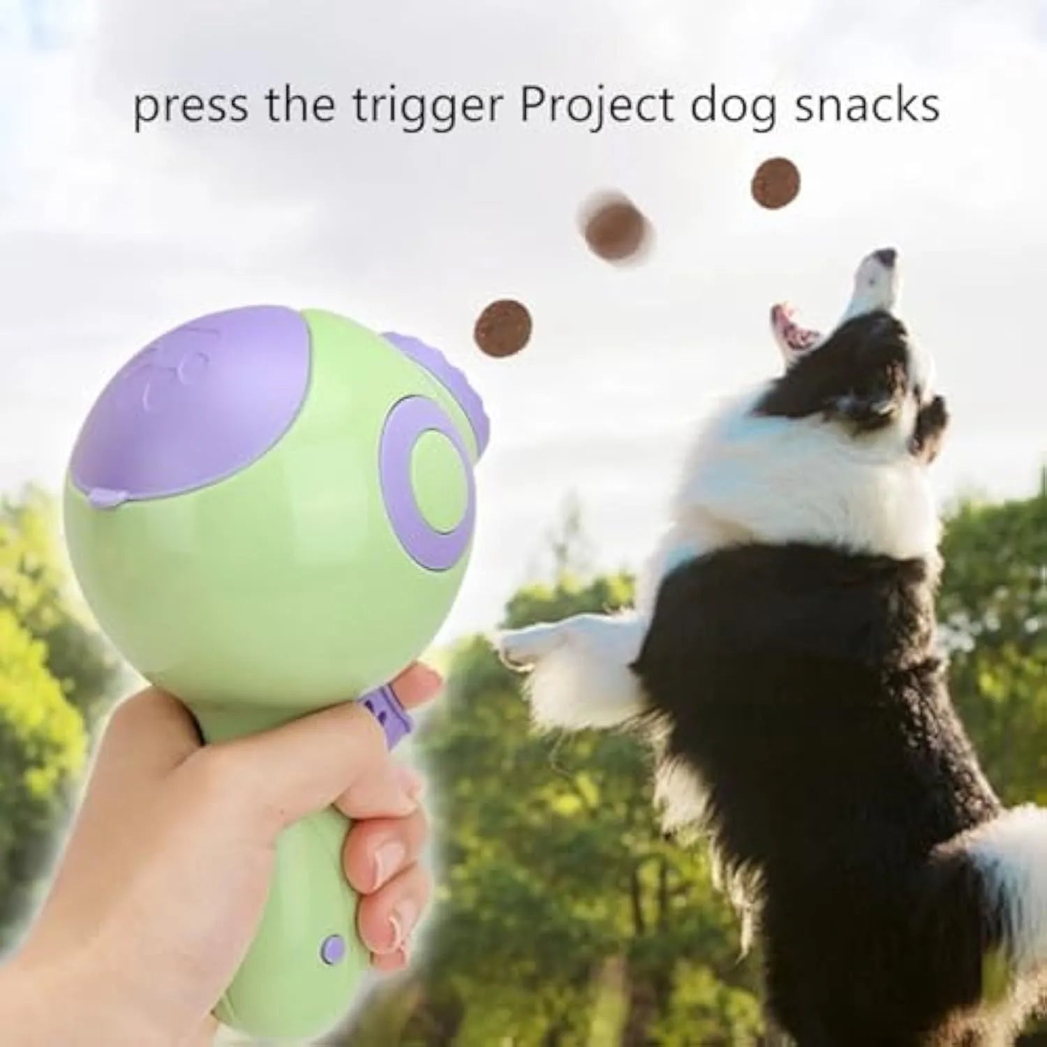 Green, orange, and pink manual dog treat launcher toy for interactive play and slow feeding.