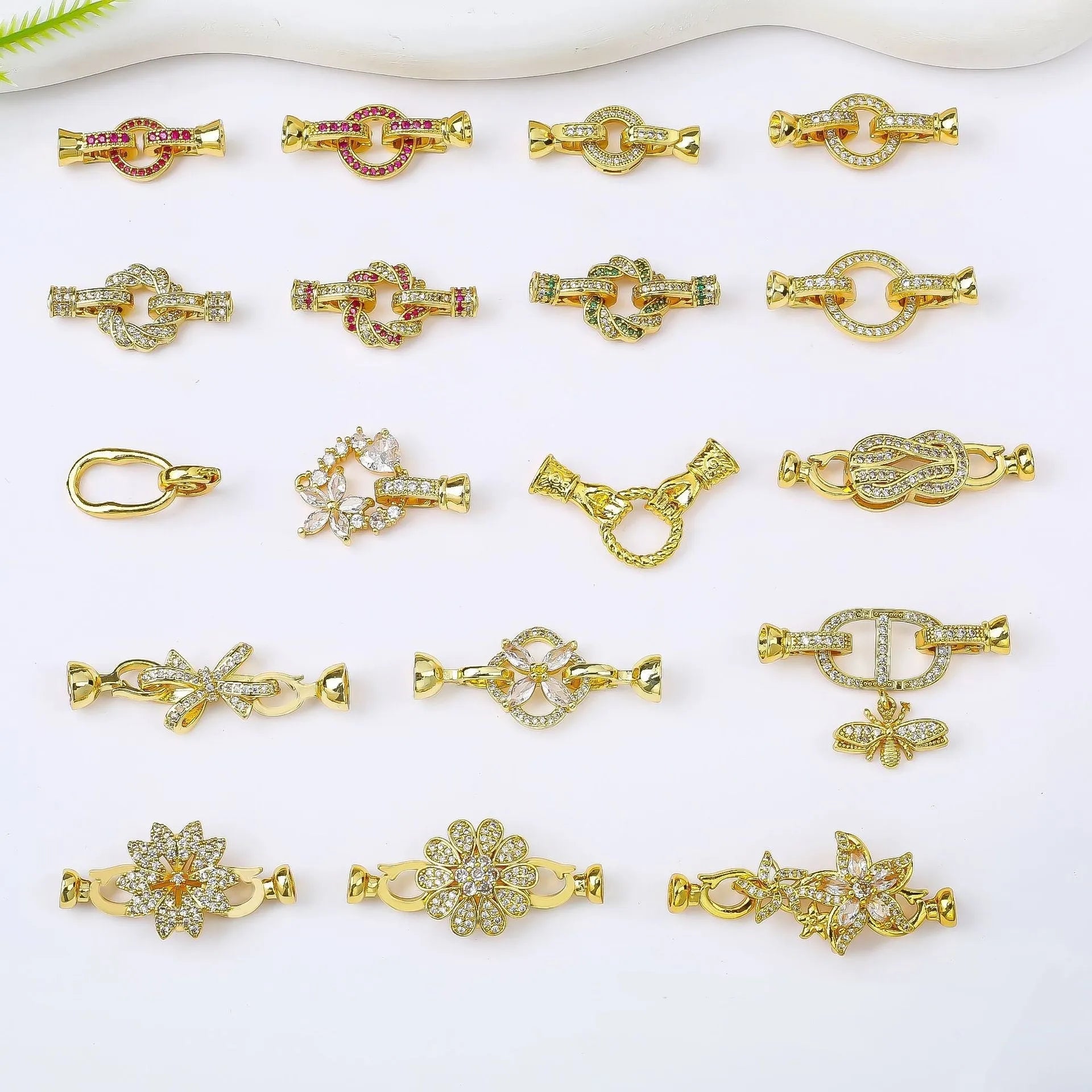 Small gold-coloured jewellery clasp with a closed loop, isolated on white background.