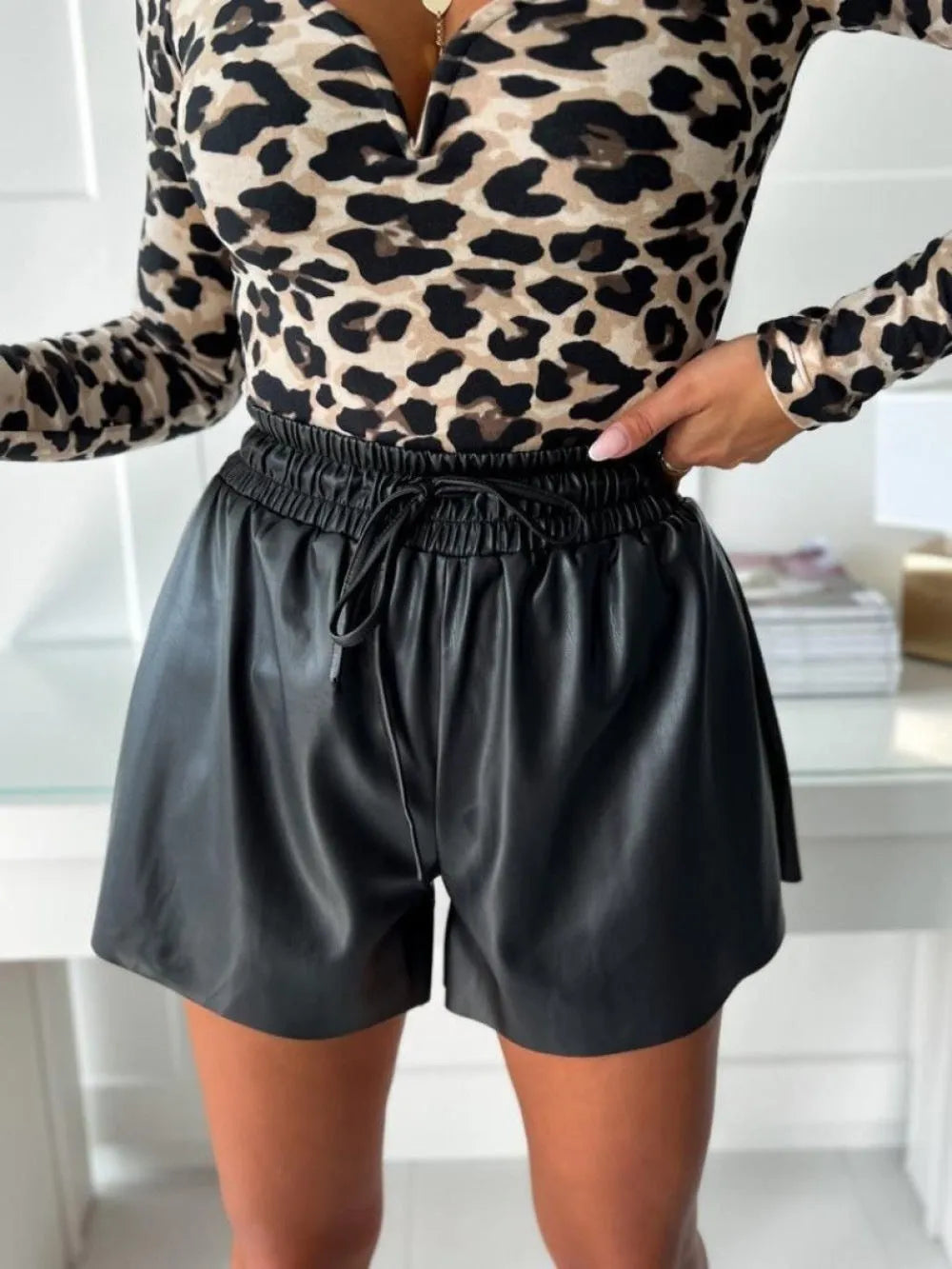 Black women's wide-leg casual shorts with drawstring lace detail on the waistband.