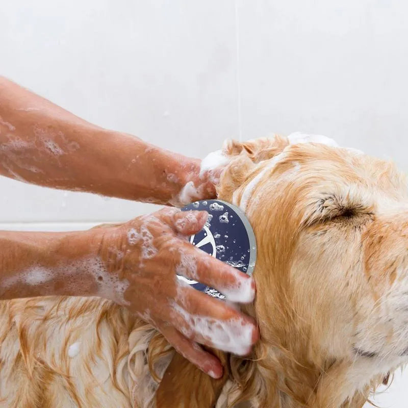 Blue handheld silicone dog shampoo brush with massage points for bath time.