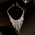 Silver diamond tassel necklace with geometric alloy pendant and ball bead chain on a light background