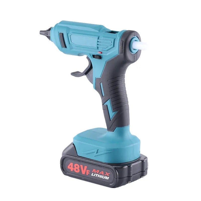 Rechargeable hot melt glue gun with lithium batteries and glue sticks on work surface