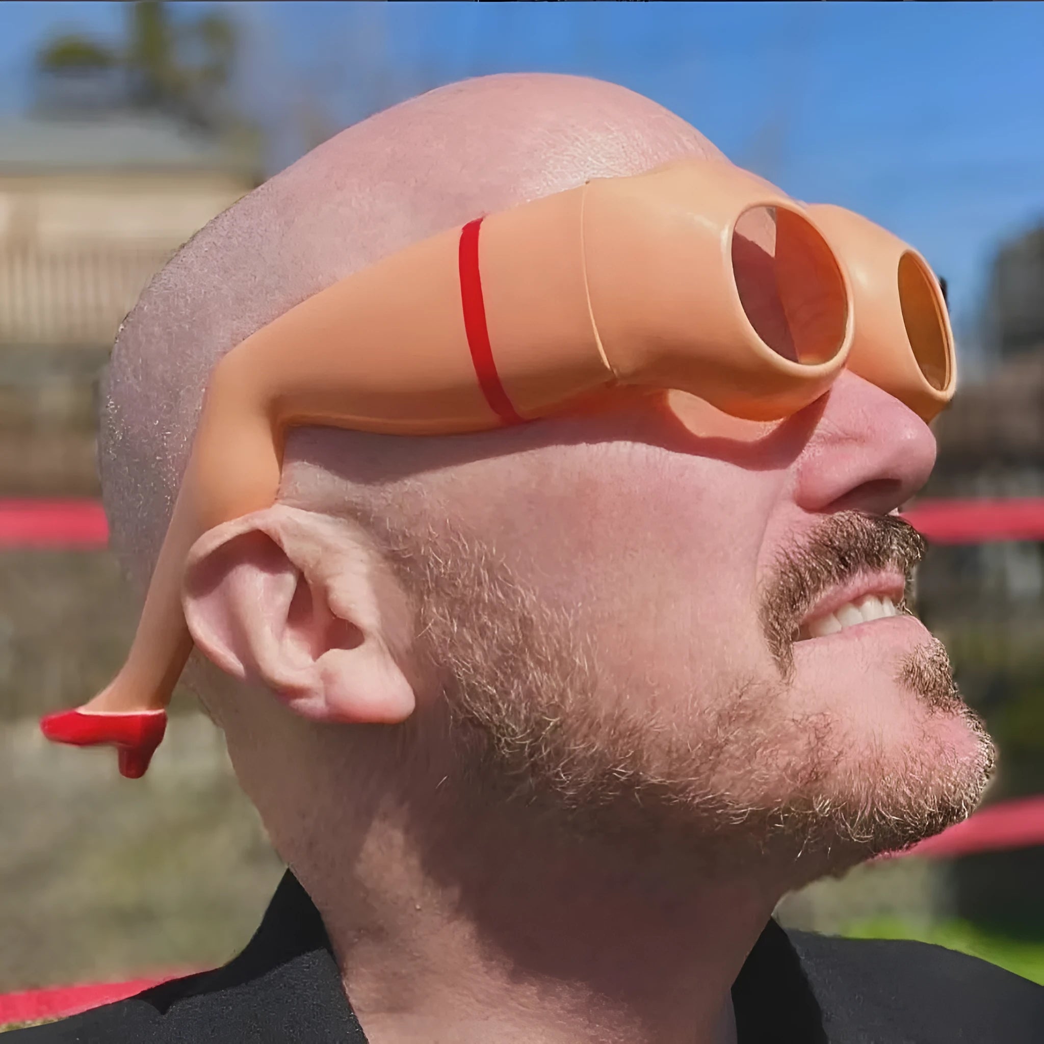 Orange novelty sunglasses with a unique Leg Hip silhouette and oversized plastic frame.