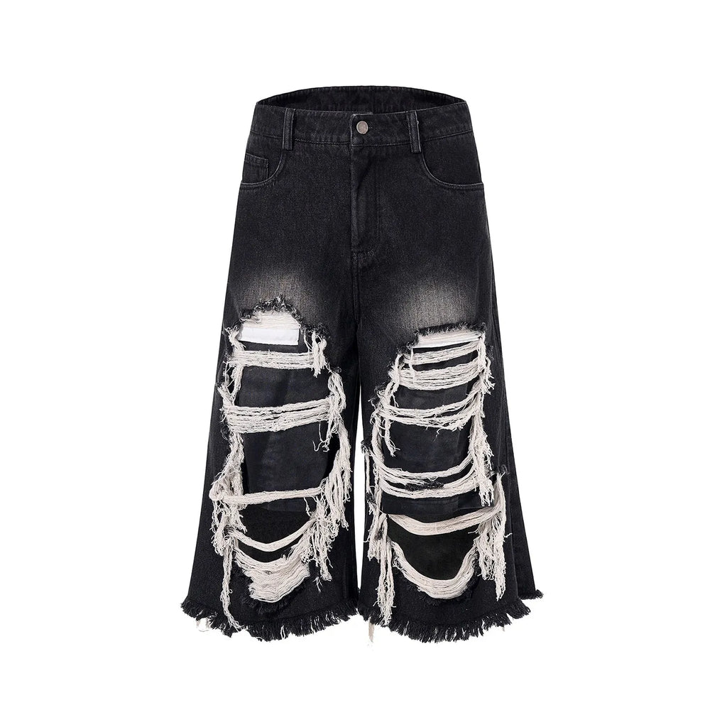 Black cropped wide-leg jeans with ripped patch details and mid-high waist