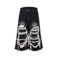 Black cropped wide-leg jeans with ripped patch details and mid-high waist
