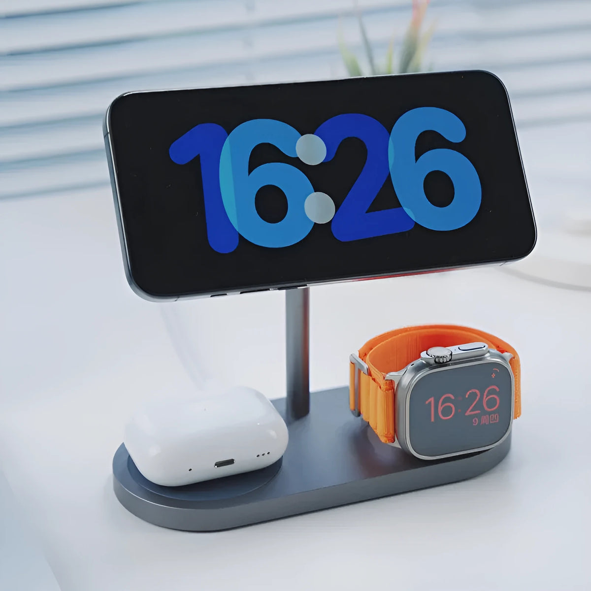Three-in-one magnetic wireless charger with aluminium alloy body in gray finish, charging a smartphone and watch