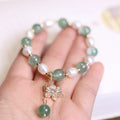 Green strawberry freshwater pearl bracelet with Chinese knot and peace buckle design