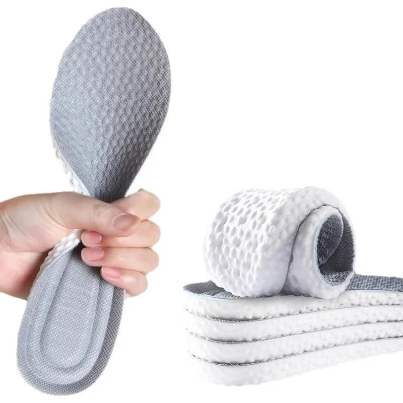 A pair of soft, grey breathable sports insoles made from elastic PU material, shown with a scissors indicating the cut-to-fit feature.