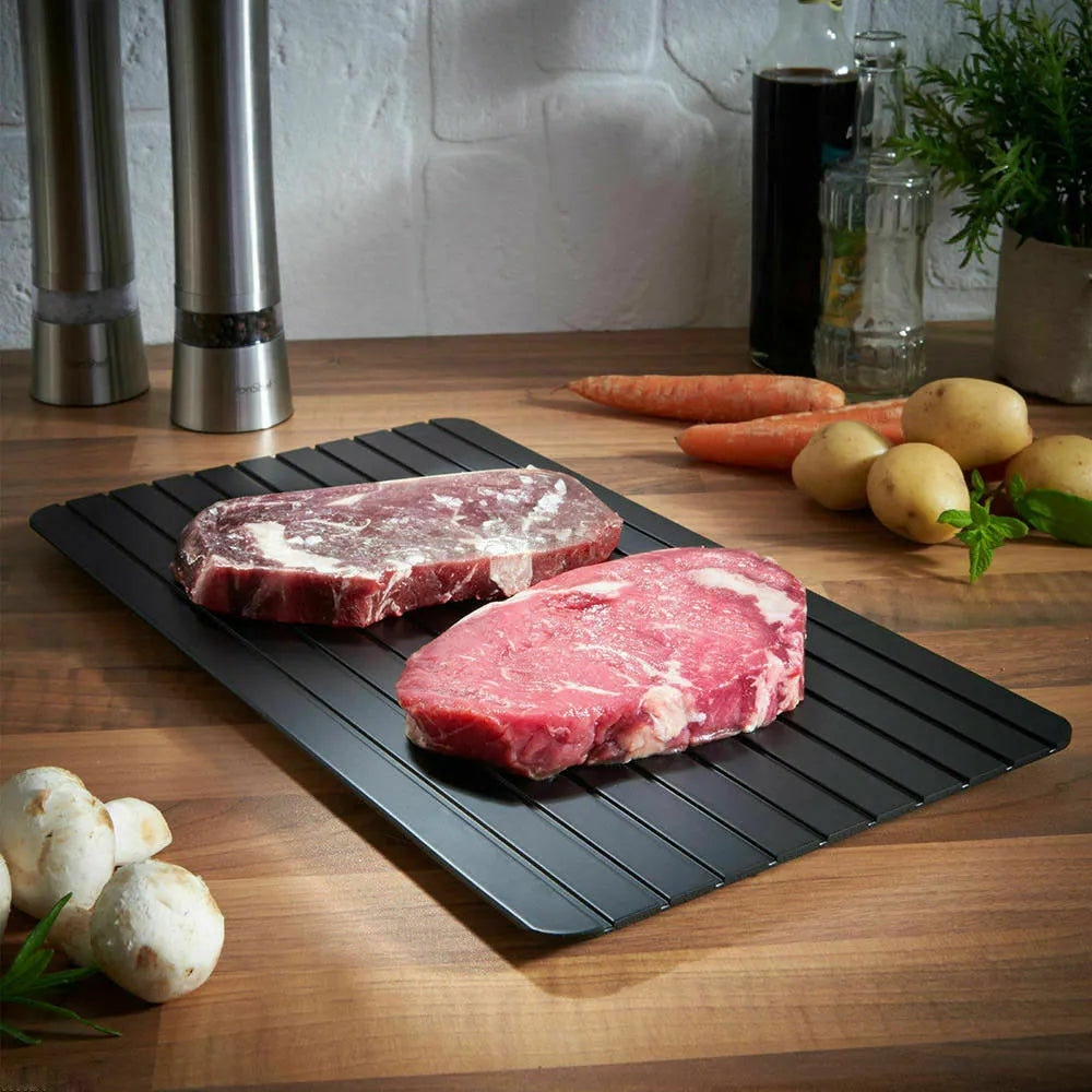 Black aluminium fast defrost tray for thawing frozen meat and food without electricity.