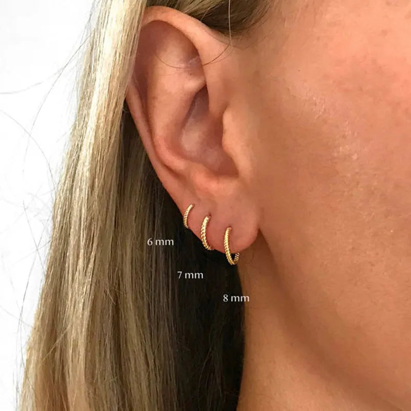 A pair of twisted sterling silver round ring earrings in a gold colour finish, shown at 13mm size.