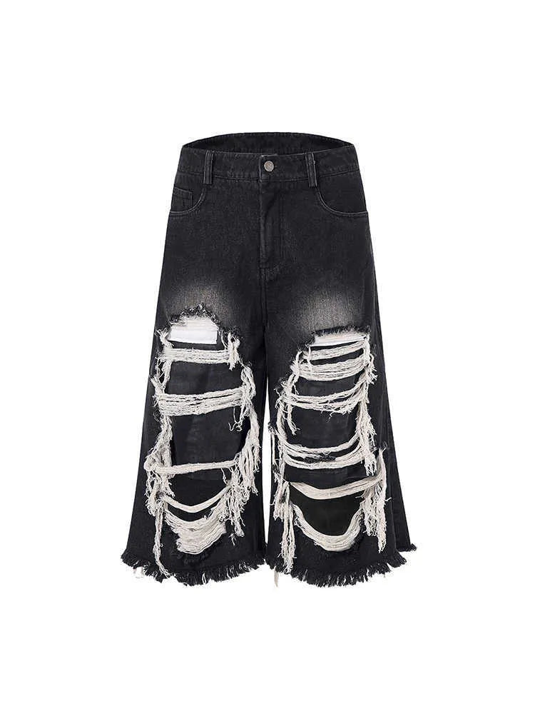Black cropped wide-leg jeans with ripped patch details and mid-high waist