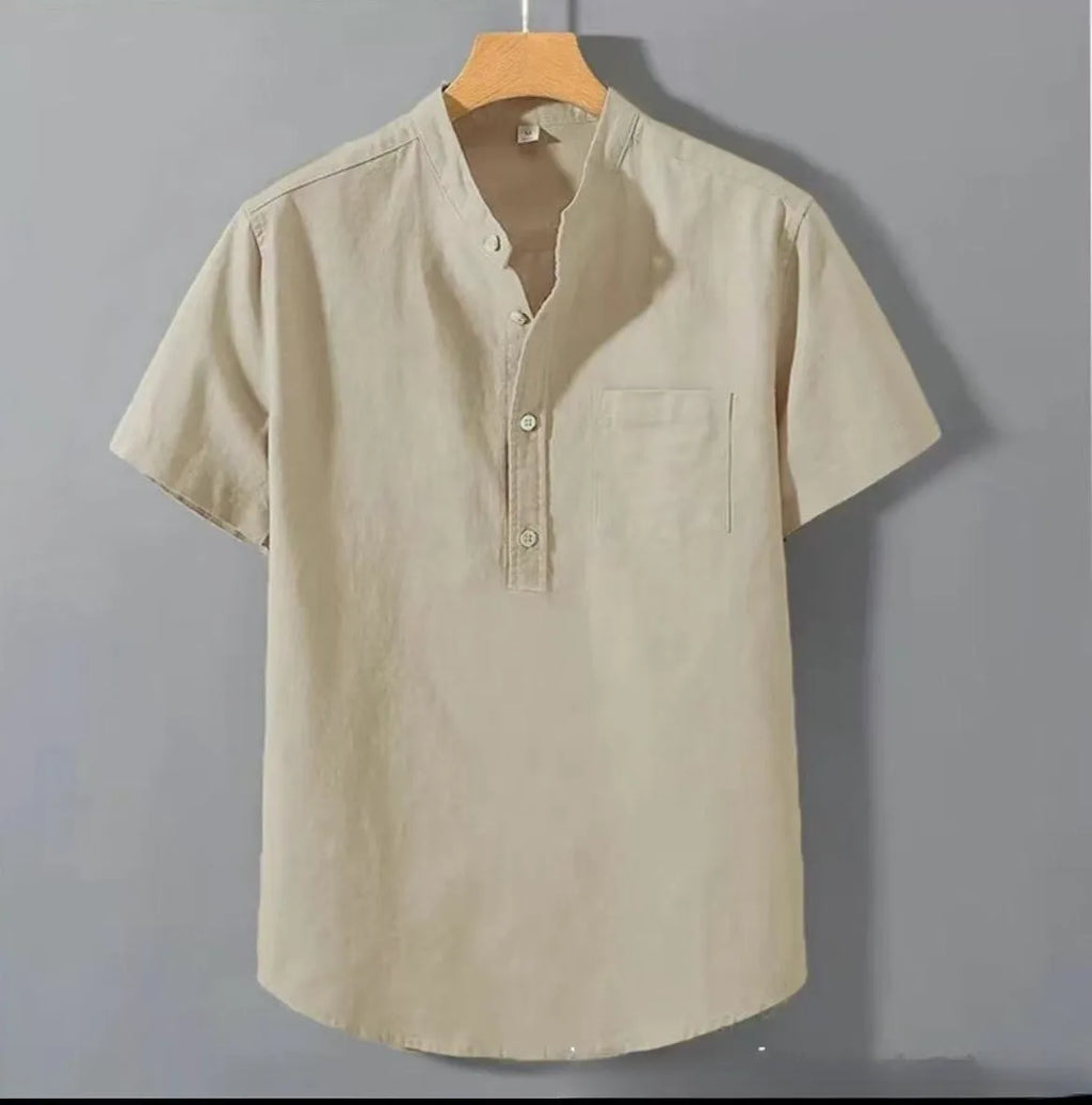 Man wearing a beige loose-fit slub linen casual shirt with a stand collar and short sleeves.