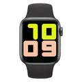 Smart watch with black silicone strap and Bluetooth earphones on wrist