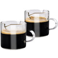 Set of white transparent glass double mouth coffee cups on a table.