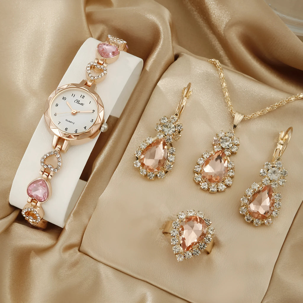 Women's quartz bracelet watch set with earrings necklace ring in pink finish on display