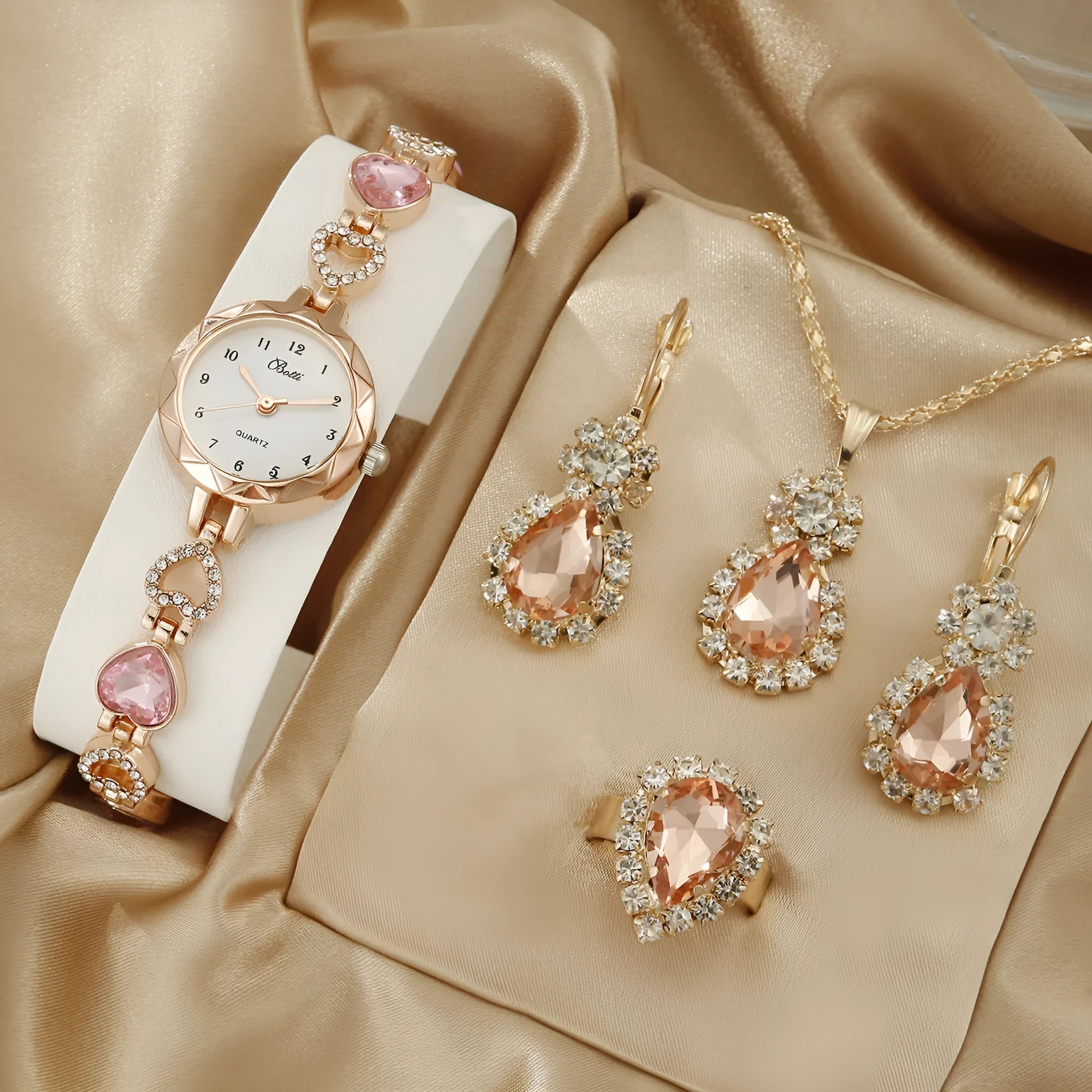 Women's quartz bracelet watch set with earrings necklace ring in pink finish on display