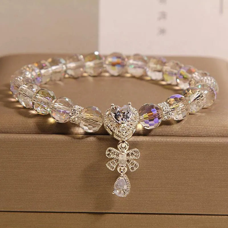 White crystal women's bracelet with butterfly and water drop charms on a metal chain, Japanese Korean style snowflake element.
