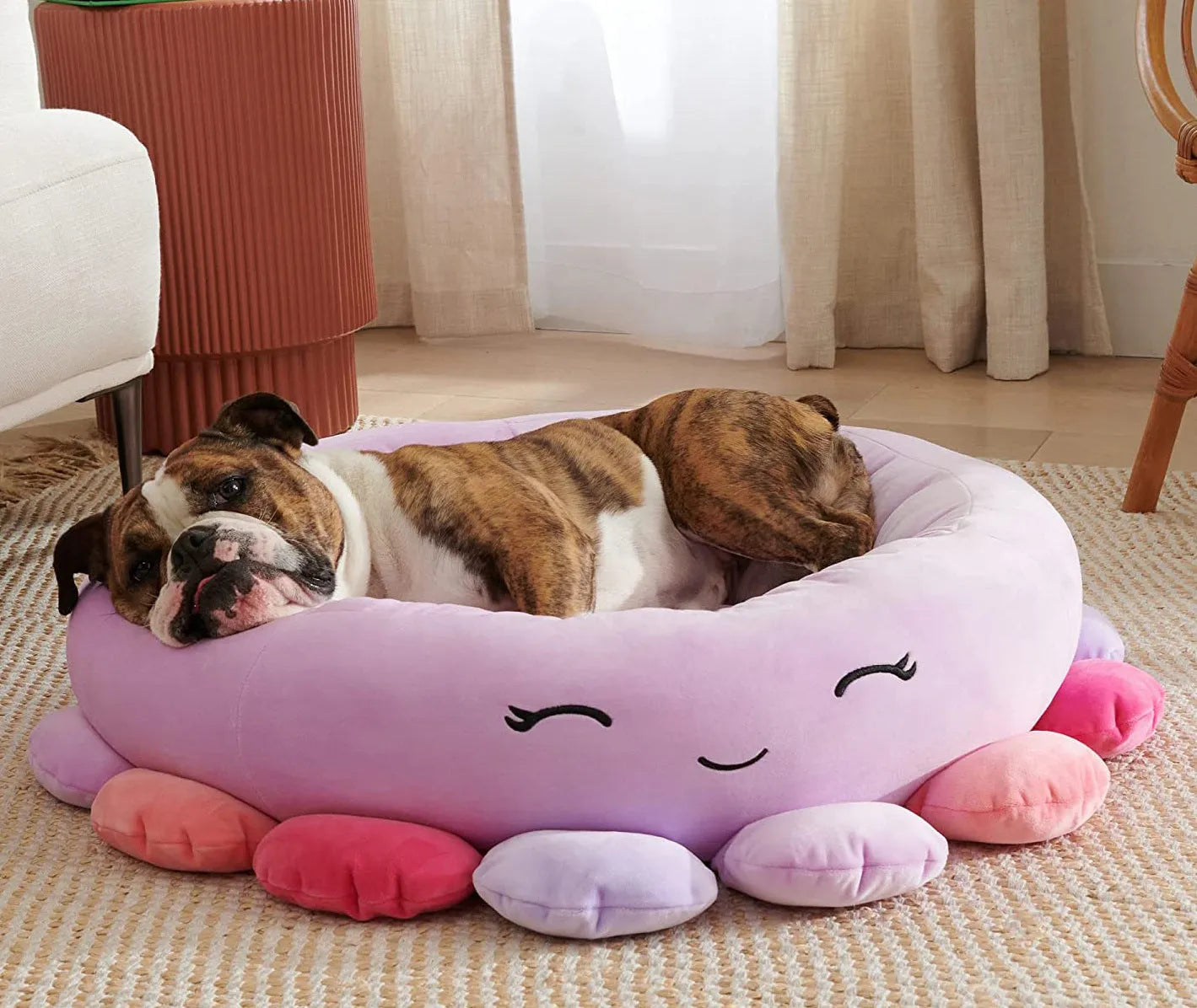 Large Squishmallows plush pet bed in green with bolster edges and non-skid bottom on floor