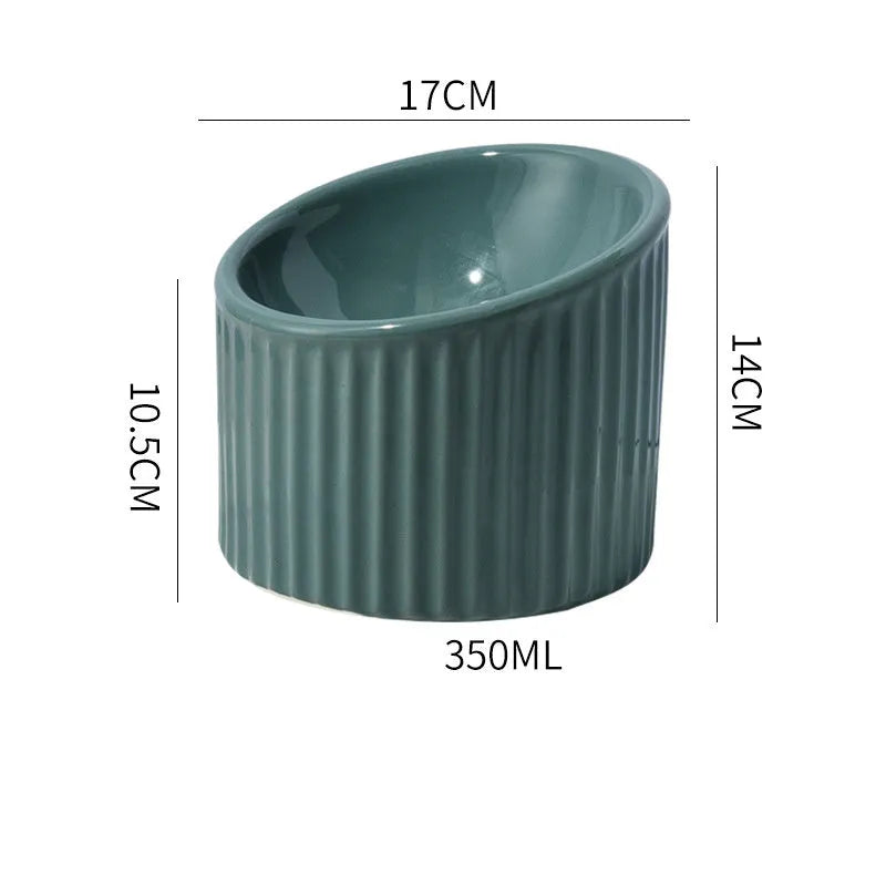 Dark green ceramic elevated cat bowl with tilted design on a raised platform.