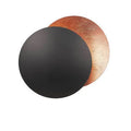 Round solar eclipse design wall lamp with iron construction in black and brass finish