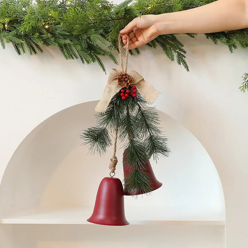 Red velvet bow bell pendant with gold bell accents on a white background