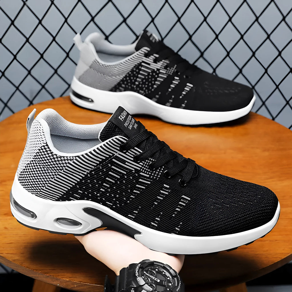 Men's low-top black and gray Flyknit mesh casual sneakers with lace-up front and round toe.
