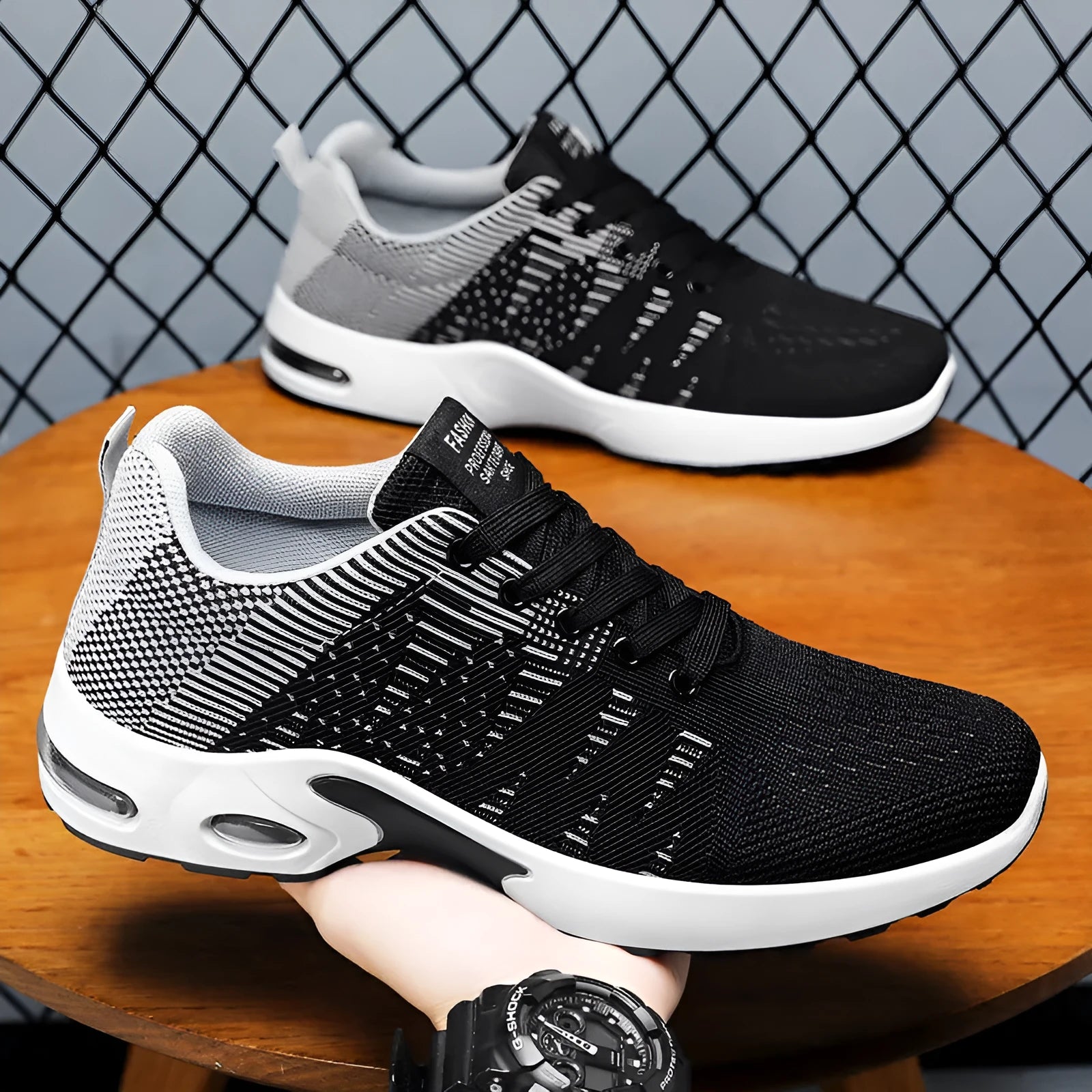 Men's low-top black and gray Flyknit mesh casual sneakers with lace-up front and round toe.