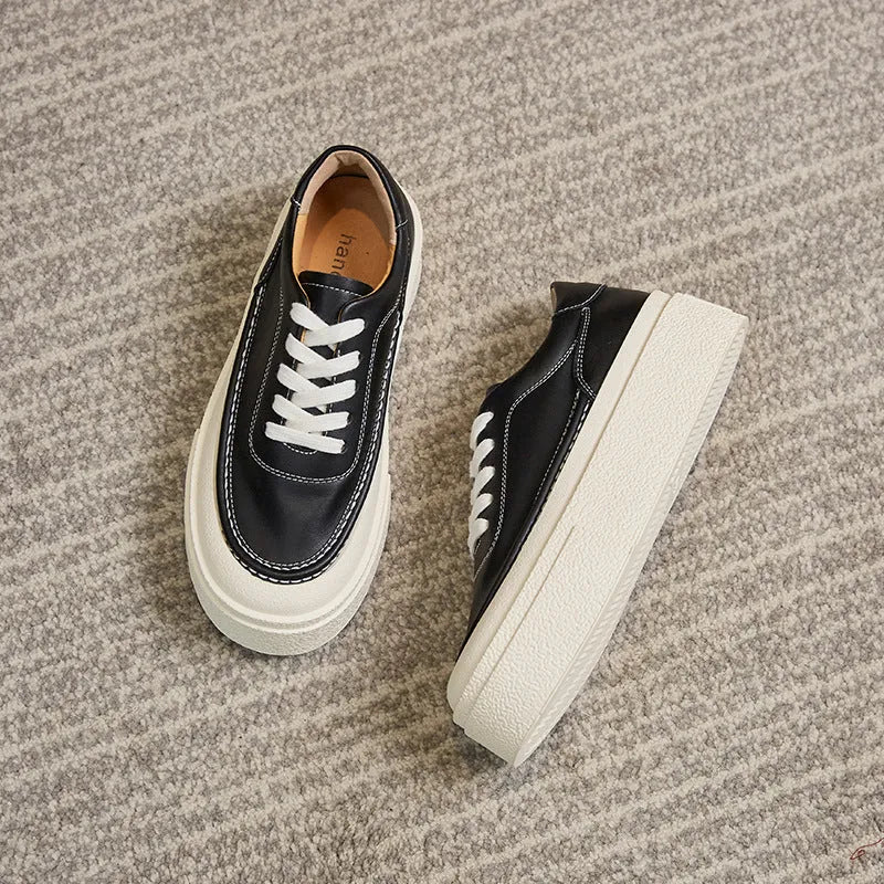 Women's black and white platform sports board shoes with embossed cowhide uppers and round toe design