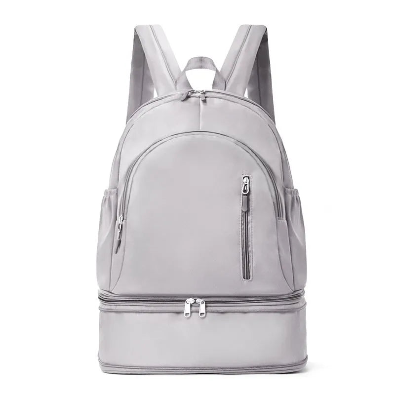 Solid colour polyester backpack with contrast stitching and curved adjustable straps, shown in grey.