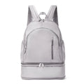 Solid colour polyester backpack with contrast stitching and curved adjustable straps, shown in grey.