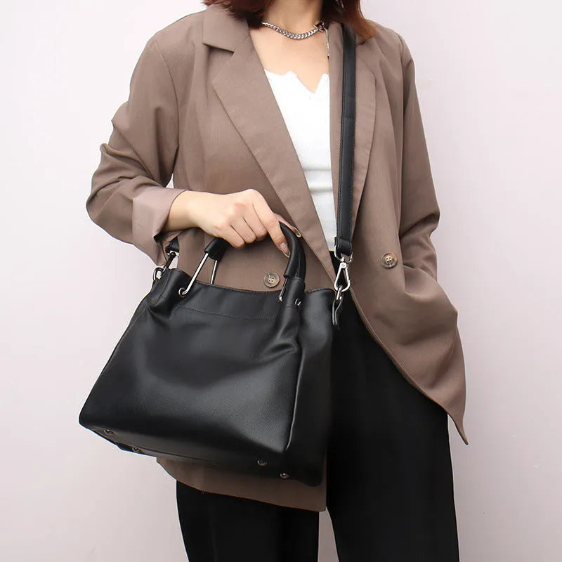Leisure soft leather bucket bag in black with slit pocket and visible sewing thread detail for commuting