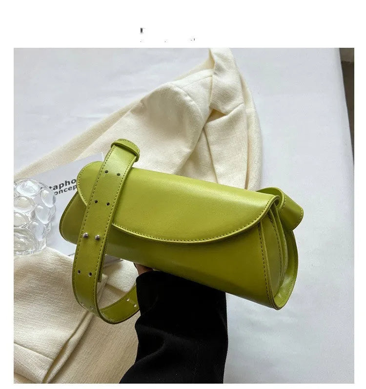 PU leather cylinder crossbody bag in black, horizontal square shape with crossbody strap