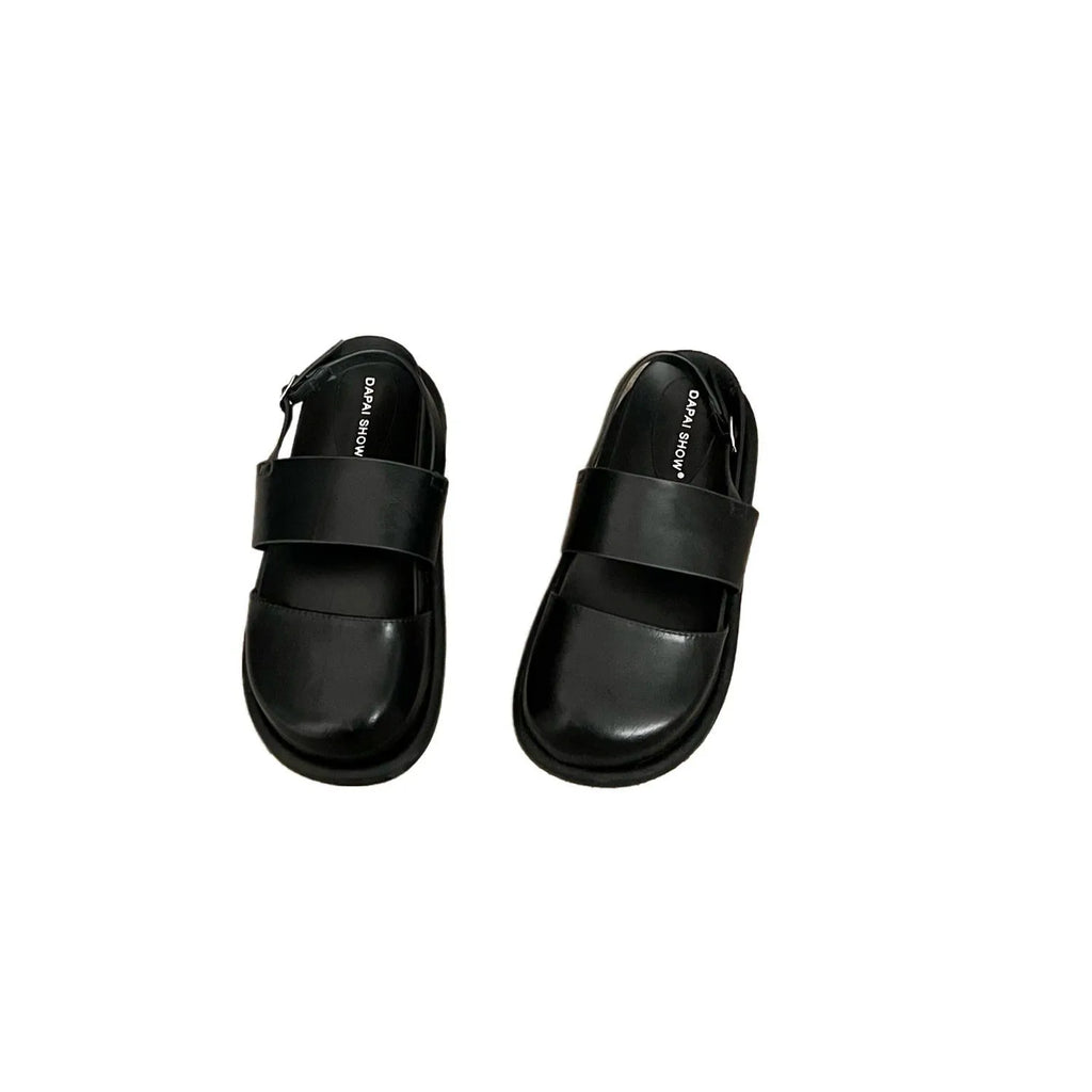 Korean style women's retro sandals with a black microfiber upper and adjustable ankle buckle on a PVC sole.