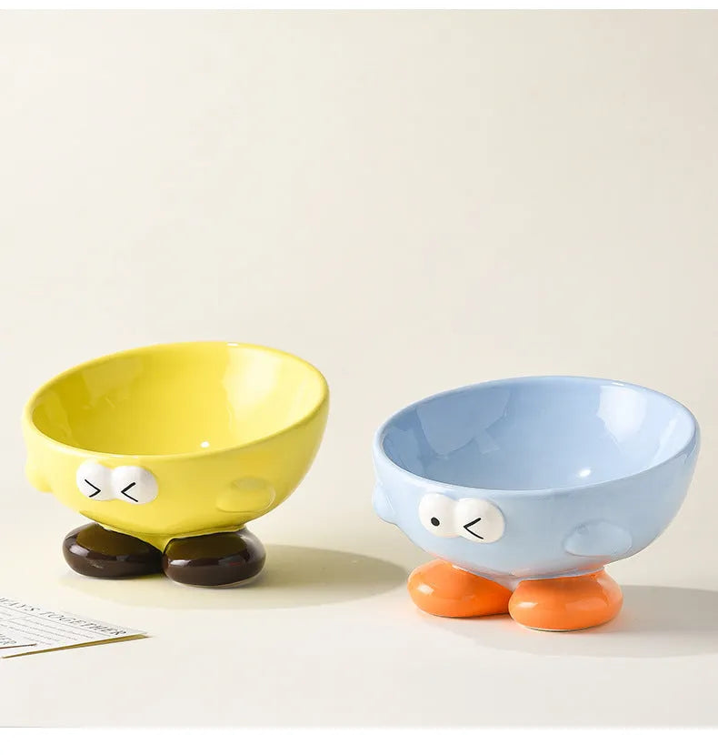 Oblique ceramic pet bowl with cute expression pattern, tall design for cervical spine protection