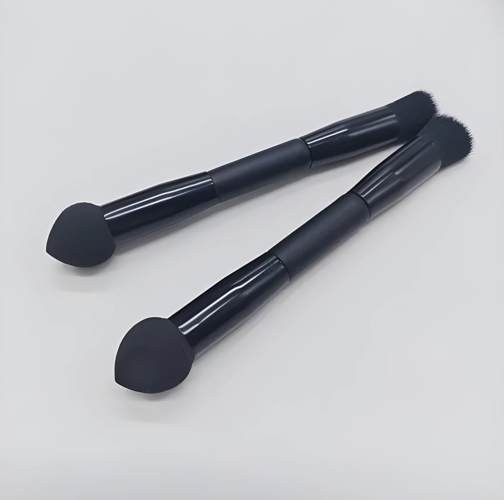Elegant black double-headed makeup brush with a synthetic fibre brush and a miter sponge on a wooden handle.