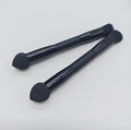 Elegant black double-headed makeup brush with a synthetic fibre brush and a miter sponge on a wooden handle.