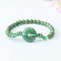Emerald green jade bracelet with safety buckle closure and star charm on wrist